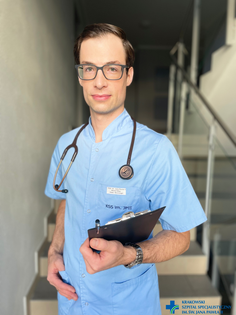 dr Błaż na schodach w niebieskim ubraniu ze stetoskopem na szyi