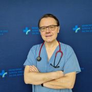 prof. dr hab. n. med. Paweł Rubiś w medycznym ubraniu na grantowym tle